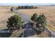 Gated property with a long, private driveway lined with mature trees, creating an inviting entrance at 9250 Steeplechase Dr, Franktown, CO 80116