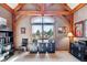 Bright home office featuring exposed wood beams, a large window with views, and built-in filing cabinets at 9250 Steeplechase Dr, Franktown, CO 80116