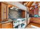 Well-equipped kitchen with custom cabinetry, a stainless steel range, and stylish backsplash details at 9250 Steeplechase Dr, Franktown, CO 80116
