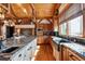Spacious kitchen with island, hardwood floors, and large windows at 9250 Steeplechase Dr, Franktown, CO 80116