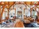 Open living area with hardwood floors and exposed beams at 9250 Steeplechase Dr, Franktown, CO 80116