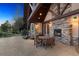 Outdoor patio with seating area and fireplace at 9250 Steeplechase Dr, Franktown, CO 80116
