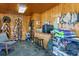Tack room with saddle racks, counter space, and storage shelves at 9250 Steeplechase Dr, Franktown, CO 80116