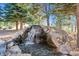 Serene waterfall feature in landscaped backyard at 9250 Steeplechase Dr, Franktown, CO 80116