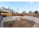 Backyard with fire pit, gravel, and wooden fence at 11310 Irma Dr, Northglenn, CO 80233