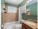 Updated bathroom with granite countertop and a bathtub at 11310 Irma Dr, Northglenn, CO 80233