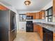 Modern kitchen with stainless steel appliances and wood cabinets at 11310 Irma Dr, Northglenn, CO 80233