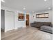 Open living room with hardwood floors and a view into the kitchen at 11310 Irma Dr, Northglenn, CO 80233