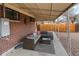 Covered patio with sectional sofa and outdoor coffee table at 11310 Irma Dr, Northglenn, CO 80233