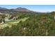 Breathtaking aerial shot captures rolling hills, green meadows, and mountain vistas in the distance at 2122 Cramner Ct, Evergreen, CO 80439