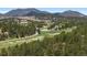 Picturesque aerial view reveals rolling hills, mountain views, and lush green landscape in a peaceful setting at 2122 Cramner Ct, Evergreen, CO 80439