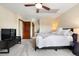 Bright bedroom with a ceiling fan, neutral carpet, and large windows at 2122 Cramner Ct, Evergreen, CO 80439
