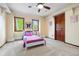 Cozy bedroom with plush carpet, natural light, and a fun butterfly decor at 2122 Cramner Ct, Evergreen, CO 80439