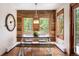 Charming dining room features rustic wood accent wall and views of the natural landscape at 2122 Cramner Ct, Evergreen, CO 80439