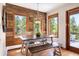 Bright dining room with wood accent wall, bench seating, and an open view at 2122 Cramner Ct, Evergreen, CO 80439