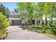 Charming two-story home featuring a two-car garage, mature trees, and manicured landscaping at 2122 Cramner Ct, Evergreen, CO 80439