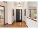 Welcoming foyer with hardwood floors, contemporary lighting and views to the outside at 2122 Cramner Ct, Evergreen, CO 80439
