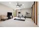 Home gym with tv, ceiling fan, treadmill, bike, weight bench and exterior view through french doors at 2122 Cramner Ct, Evergreen, CO 80439