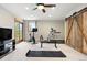 Workout room with a ceiling fan, treadmill, bike, weight bench, carpet flooring and exterior view at 2122 Cramner Ct, Evergreen, CO 80439