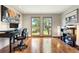 Bright home office featuring beautiful wood floors and large windows at 2122 Cramner Ct, Evergreen, CO 80439