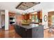 Kitchen with stainless appliances, center island, wooden cabinets and ceiling detail, and lots of light at 2122 Cramner Ct, Evergreen, CO 80439