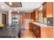 A gourmet kitchen features a large island and stainless steel appliances, and rich wood cabinets at 2122 Cramner Ct, Evergreen, CO 80439