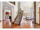 Bright and spacious living room featuring a stone fireplace and stairs to the second story at 2122 Cramner Ct, Evergreen, CO 80439
