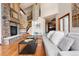 Spacious living room boasting a stone fireplace, hardwood floors, and an open floor plan at 2122 Cramner Ct, Evergreen, CO 80439