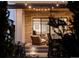 Cozy covered patio with a ceiling fan, outdoor seating, and stone accents, offering a great entertainment space at 5985 Galena St, Denver, CO 80238
