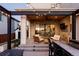 Covered back patio with stylish seating, stone accents, string lights, and built-in bar, ideal for relaxation at 5985 Galena St, Denver, CO 80238