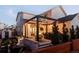 Inviting backyard featuring a covered patio, outdoor bar, fire pit area, and landscaped yard, perfect for entertaining at 5985 Galena St, Denver, CO 80238