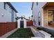 View of a well-maintained backyard featuring a small shed, green grass, and a stone retaining wall at 5985 Galena St, Denver, CO 80238