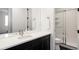 Contemporary bathroom featuring a modern vanity, gold hardware, and shower with glass door at 5985 Galena St, Denver, CO 80238