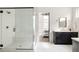 Modern bathroom featuring a glass-enclosed shower, vanity, and a bedroom view at 5985 Galena St, Denver, CO 80238