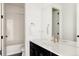 Modern bathroom with a sleek vanity, quartz countertop, gold hardware and white subway tile in the shower at 5985 Galena St, Denver, CO 80238