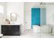 Beautiful bathroom featuring turquoise tile accent wall and a standalone tub at 5985 Galena St, Denver, CO 80238