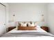 Bright bedroom featuring a king-sized bed, cozy textiles and stylish sconces at 5985 Galena St, Denver, CO 80238