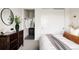 Bright bedroom featuring a closet, dark wood dresser and ensuite bathroom at 5985 Galena St, Denver, CO 80238