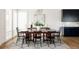 Elegant dining room featuring a large wooden table, modern lighting, and sophisticated decor at 5985 Galena St, Denver, CO 80238