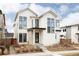 Striking two-story modern farmhouse featuring clean lines, dark accents, and professional landscaping at 5985 Galena St, Denver, CO 80238