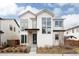 Striking modern farmhouse with white siding, black trim, and large windows creates a bold and inviting curb appeal at 5985 Galena St, Denver, CO 80238