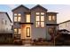 Modern two-story home with striking architectural details, large windows, and well-manicured landscaping at 5985 Galena St, Denver, CO 80238
