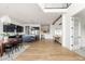 Open-concept living space showcasing a modern kitchen, dining area, and expansive hardwood floors at 5985 Galena St, Denver, CO 80238