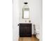 Stylish powder room with dark wood vanity, gold mirror, and modern fixtures at 5985 Galena St, Denver, CO 80238