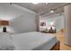 Comfortable bedroom with lamp-lit nightstand and partition to living area boasts tranquil natural light at 1401 Wewatta St # 202, Denver, CO 80202