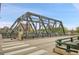 Long low angle view of the metal bridge over a city street with buildings and blue skies in the background at 1401 Wewatta St # 202, Denver, CO 80202