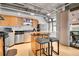 Modern kitchen with stainless appliances, breakfast bar and outside views, perfect for cooking and dining at 1401 Wewatta St # 202, Denver, CO 80202