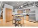 Modern kitchen with stainless steel appliances, island with breakfast bar, and ample cabinet space at 1401 Wewatta St # 202, Denver, CO 80202