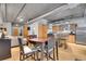 Open floor plan with exposed ductwork offers a dining area and kitchen with stainless steel appliances at 1401 Wewatta St # 202, Denver, CO 80202