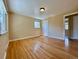 Bedroom with hardwood floors, neutral paint, window, baseboard trim and a door to another room at 1801 S Grove St, Denver, CO 80219